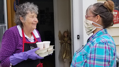 Meals on Wheels driver delivers to Sharron Miller